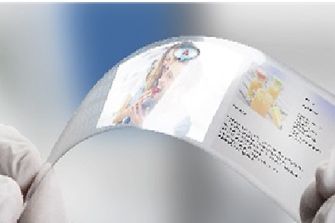 Image of gloved hand holding transparent films for consumer electronics displays.